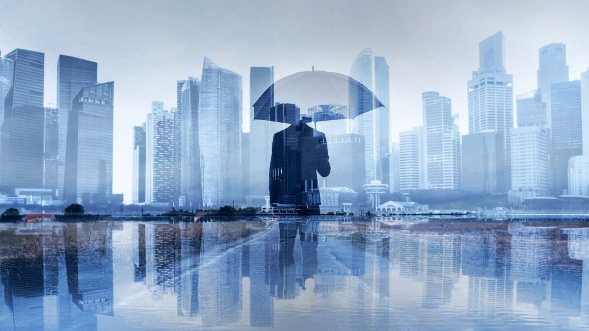 insurance concept, risk in business, businessman with umbrella