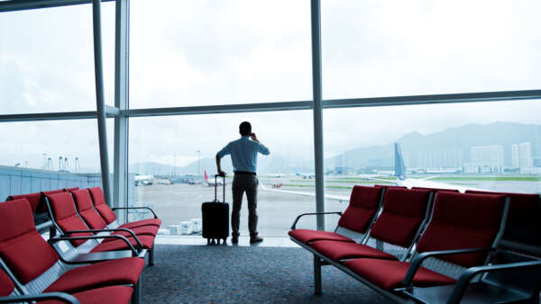 business traveler with luggage waiting for his flight.